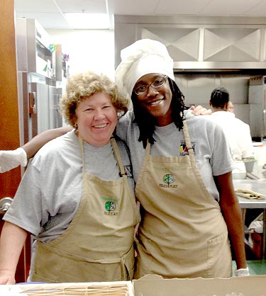 Two volunteers in kitchen